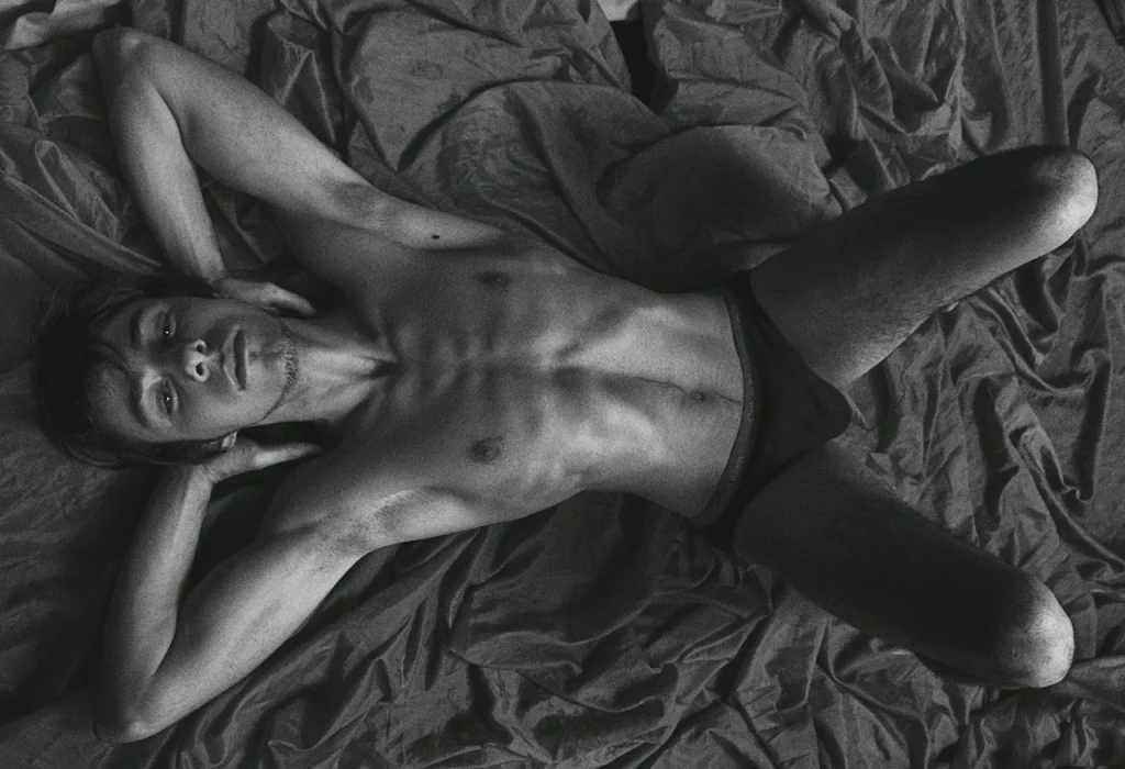 Gay man lying comfortably in bed for self-pleasure and sexual wellness
