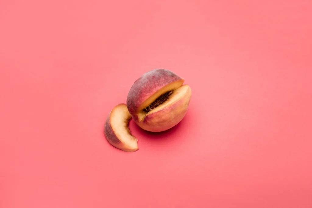 Peach on pink background representing anal exploration and self-pleasure safety
