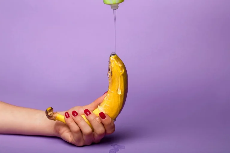 Water-based lubricant being applied to banana for lubricant comparison guide